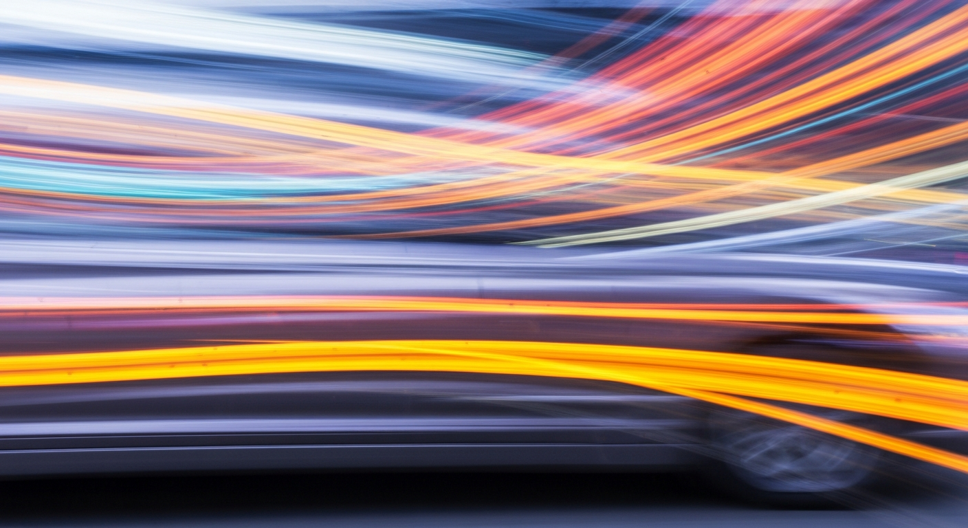 Heavily blurred, abstract streaks of color representing a moving car, conveying a sense of speed, modern engineering, and the challenges of maintaining accurate automotive advertising.