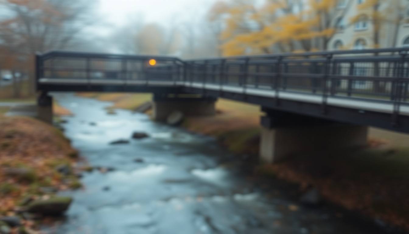 An impressionistic, out-of-focus photograph depicting the hazy silhouette of a pedestrian bridge over a flowing creek, with warm, autumnal colors blending together in a dreamlike, atmospheric scene.
