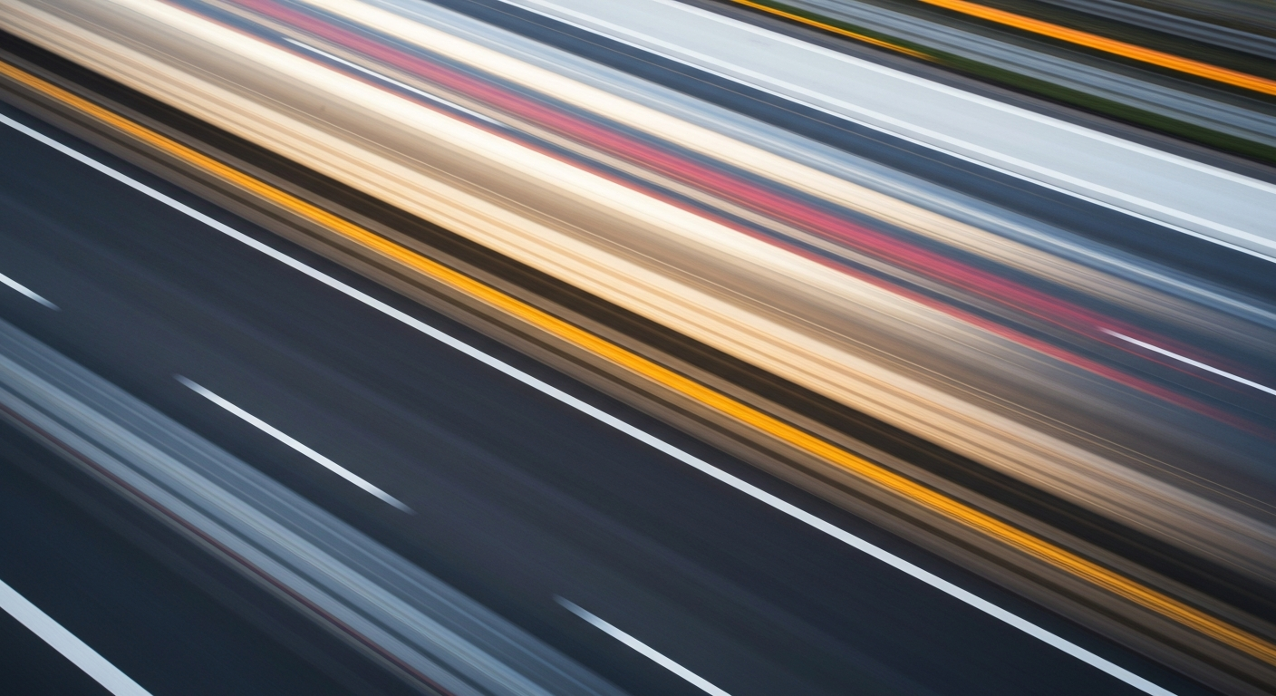 An abstract, blurred image of a car speeding down a highway, with vibrant streaks of color representing the motion and energy of the scene.