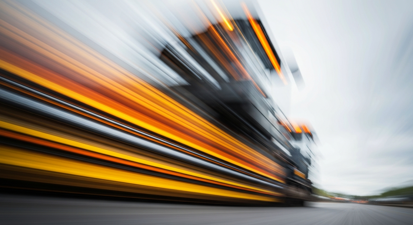 An abstract, blurred image of construction equipment in motion, with vibrant streaks of orange, yellow, and grey, conveying the energy and progress of a road improvement project.