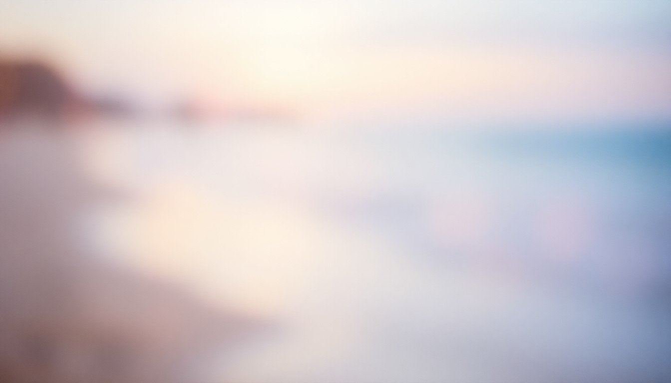 An impressionistic, out-of-focus photograph depicting a hazy, sun-dappled beach scene, with soft pools of warm light and color creating a dreamlike, atmospheric mood.