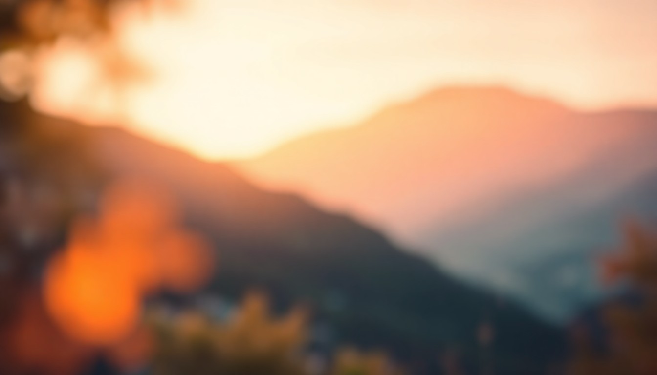 An extremely abstracted, out-of-focus photograph shot through condensation or rain-streaked glass, composed of soft pools of warm color and light depicting a tranquil outdoor scene with a mountain landscape in the background.
