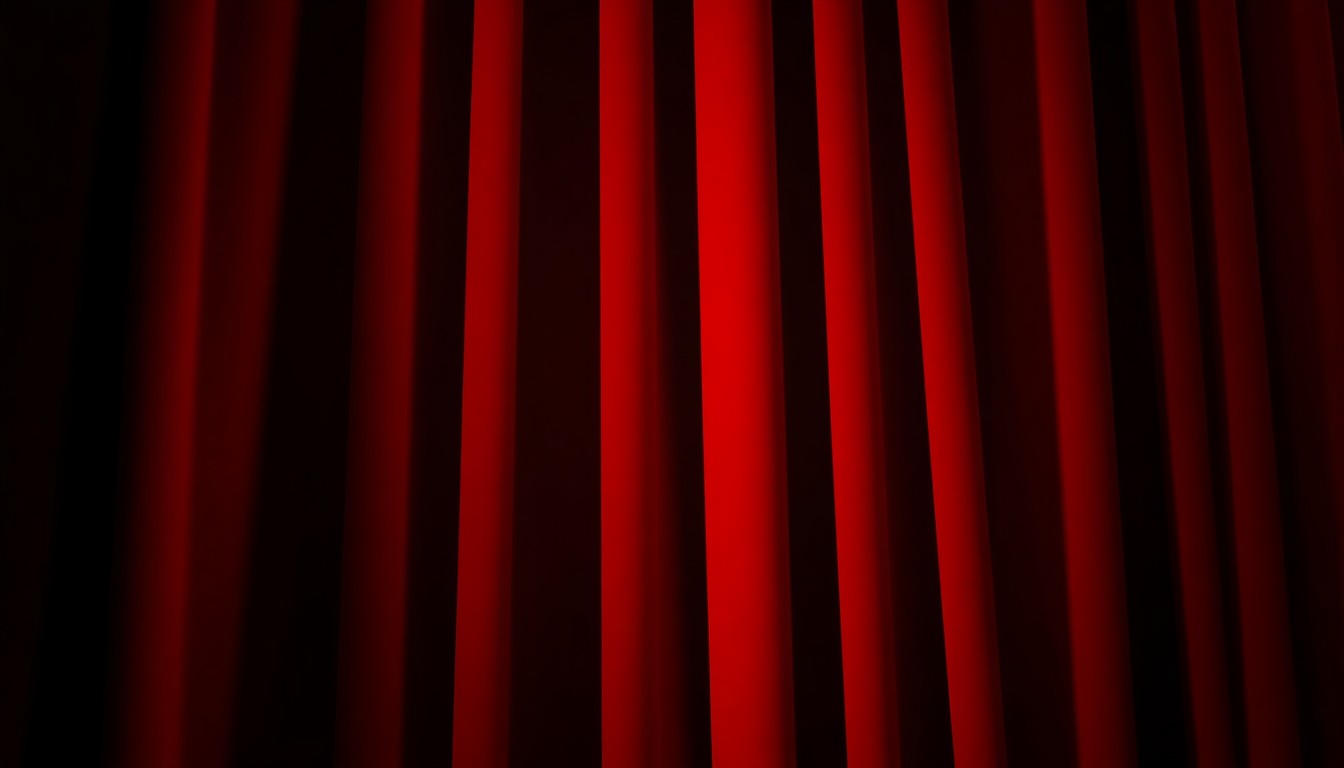 An extreme close-up photograph of a plush, deep red theater curtain, the fabric's texture filling the frame in an abstract, high-contrast composition that evokes the anticipation and glamour of a live comedy performance.