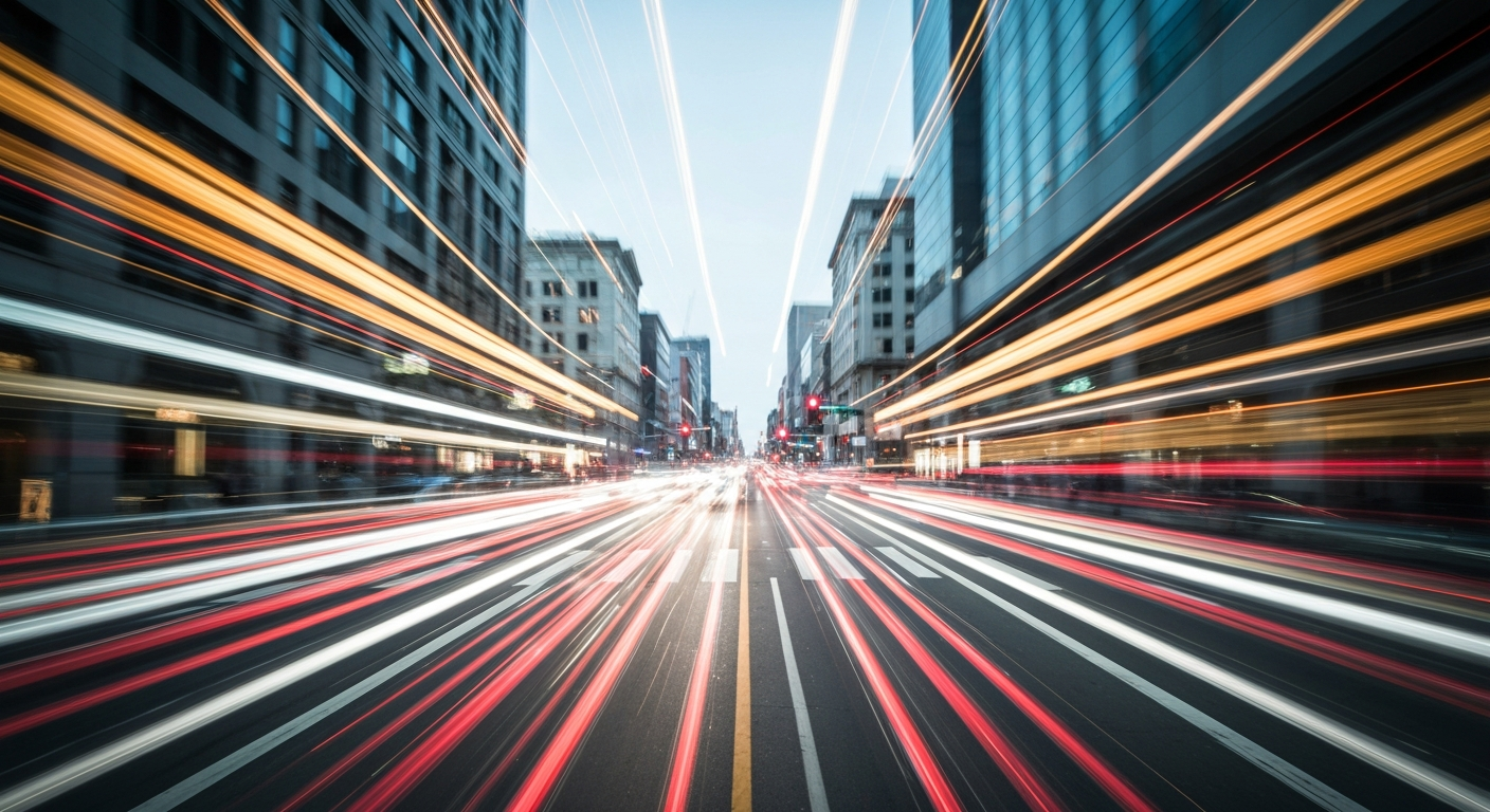 An abstract, colorful blur of motion depicting a busy urban intersection, conveying the energy and flow of traffic in a dynamic, artistic style.