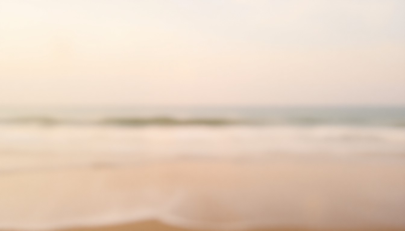 An extremely blurred, impressionistic photograph of a coastal shoreline, with waves gently lapping at the sand and a hazy horizon line visible through soft, warm pools of light and color, conceptually representing the transitional nature of moving from planning to implementation for coastal resilience initiatives.