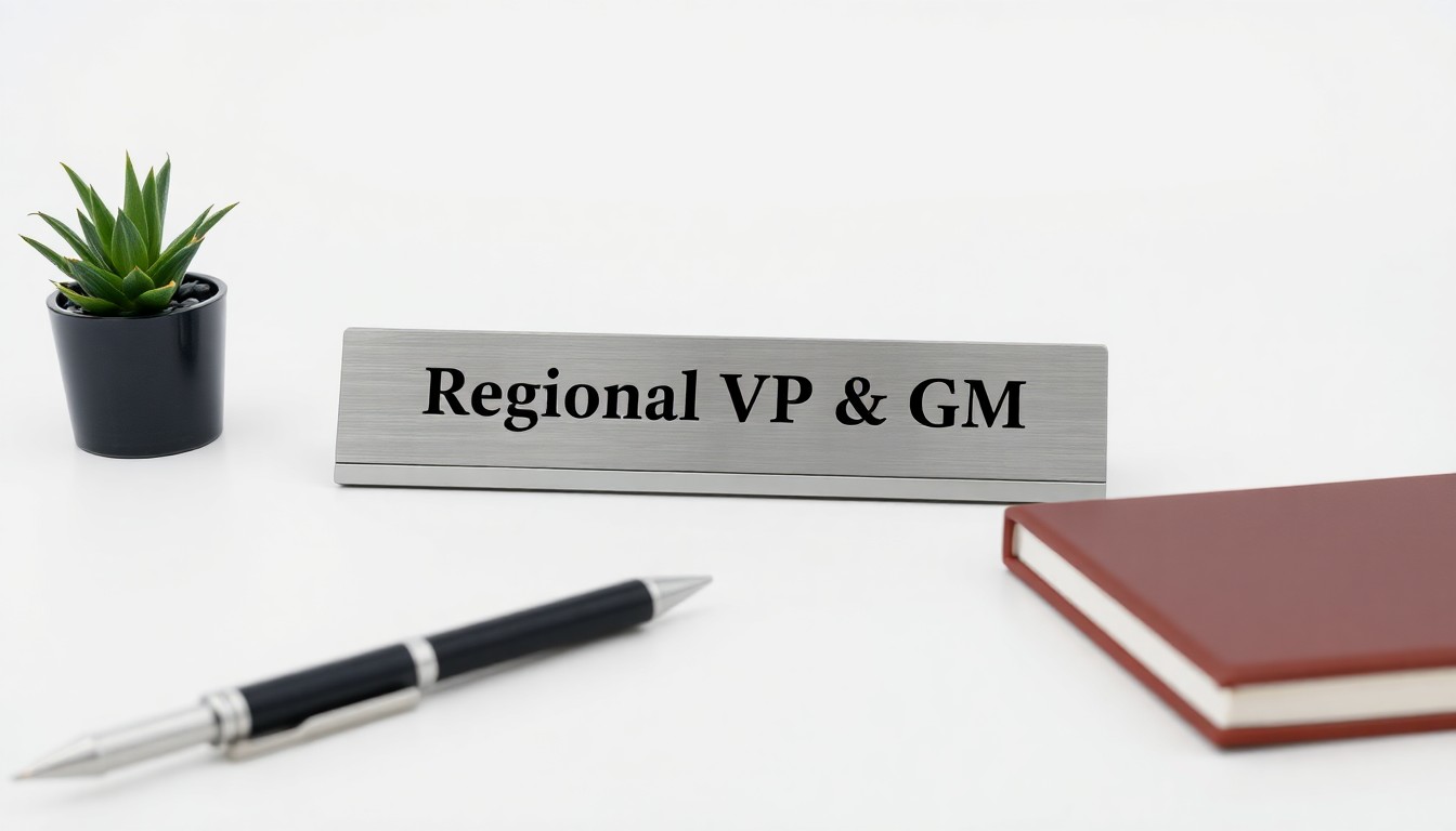 A minimalist studio photograph featuring a polished metal desk nameplate with the words 'Regional VP & GM' engraved on it, placed on a clean white background and surrounded by a few other premium office objects like a pen, a notebook, and a small potted plant, conceptually representing the shift towards shared leadership in the TV industry.