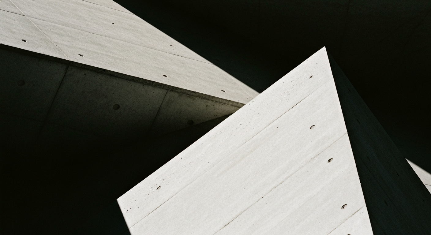 An extreme close-up of the rough, pebbled concrete surface of a parking garage facade, with dramatic shadows and highlights that give the material a sculptural, almost abstract quality.