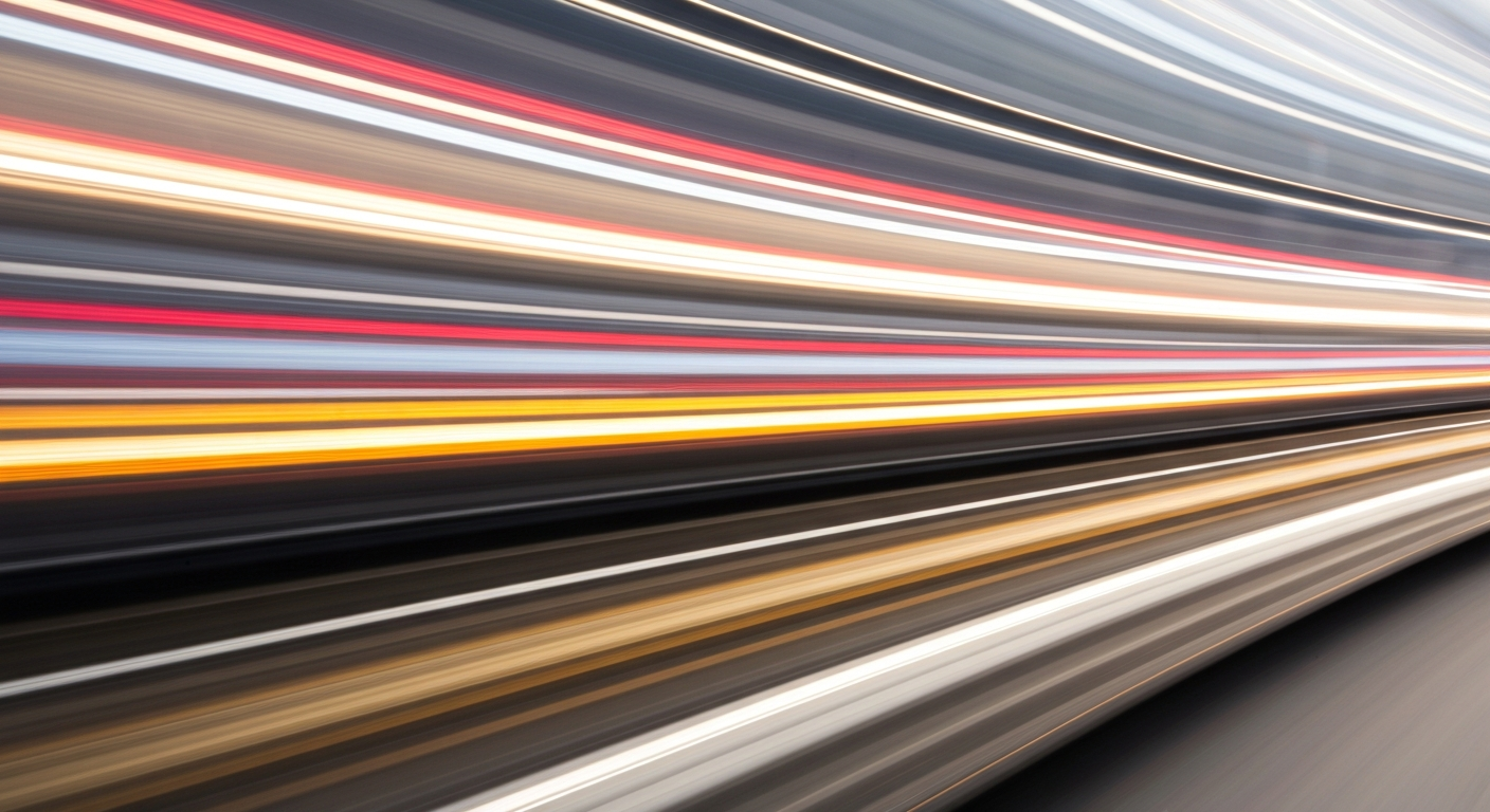 An abstract, blurred image of a moving vehicle, conveying a sense of speed, modern engineering, and travel through sweeping streaks of vibrant color.